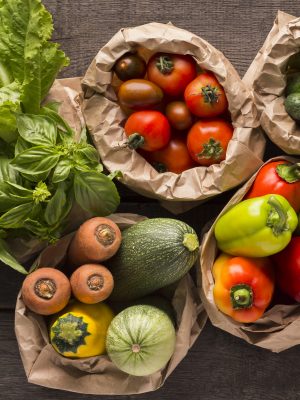 Close up of fresh eco vegetables in coton bags on wood